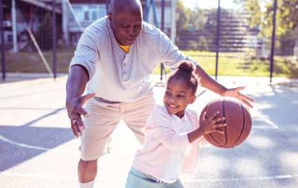 Father and daughter playing basketball