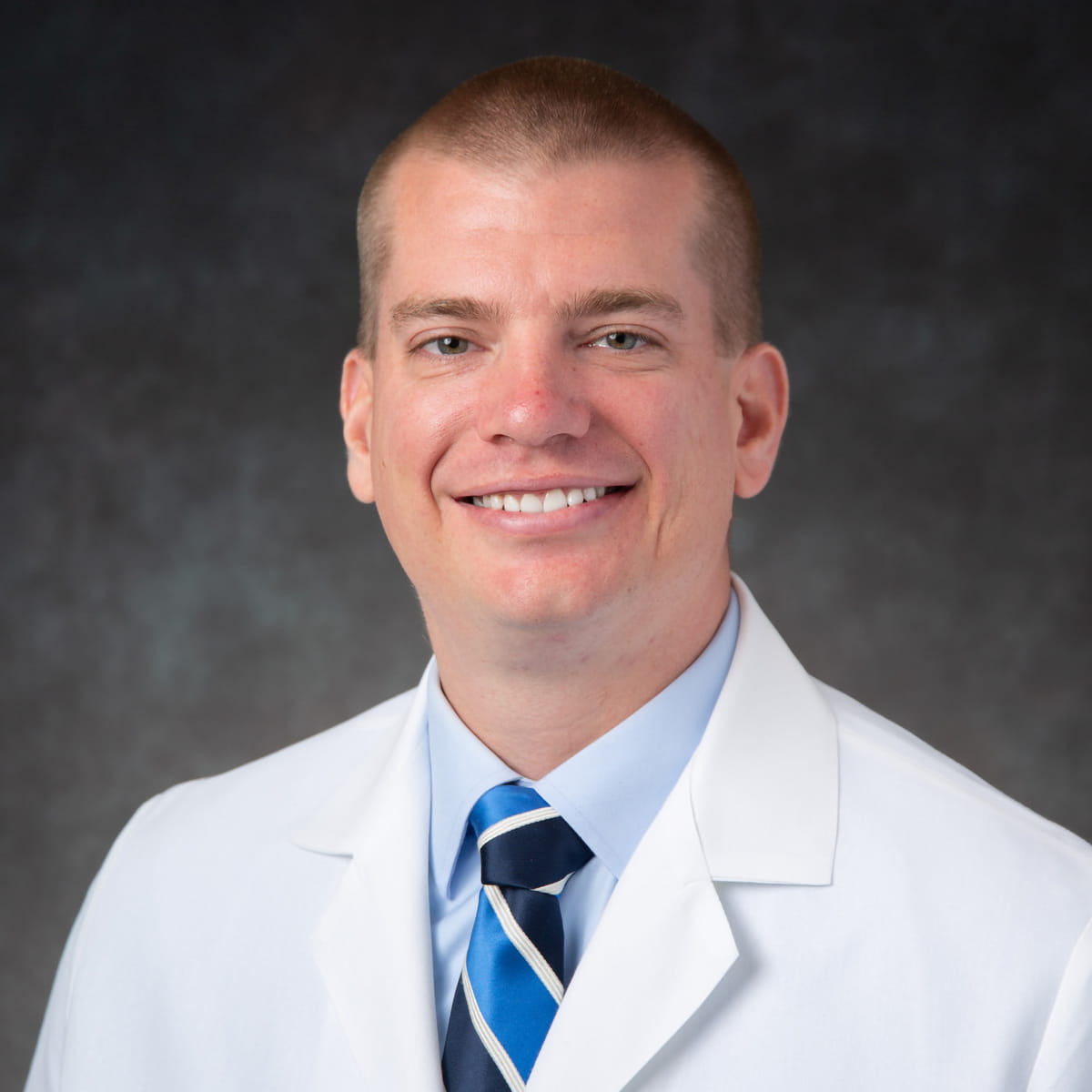 A friendly headshot of Adam Ferro, MD