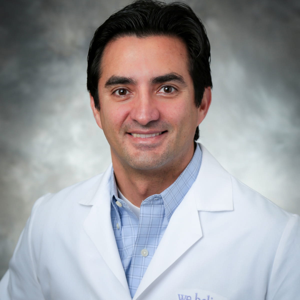 A friendly headshot of Carlos Alarcon, MD