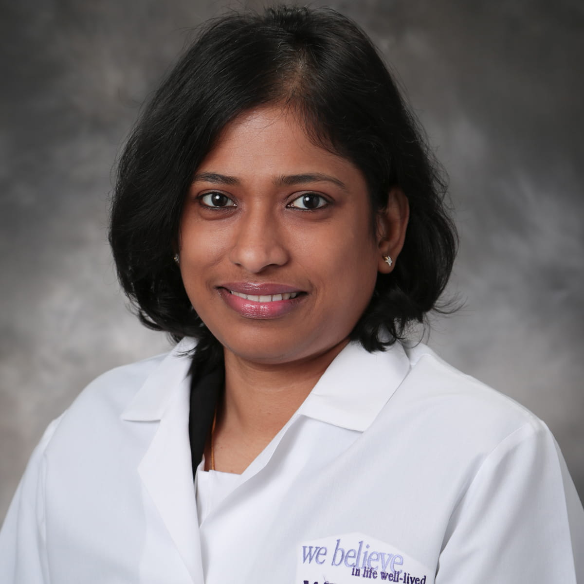 A friendly headshot of Erosha Jayawardena, MD