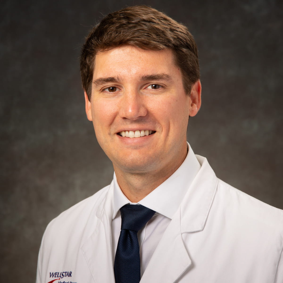 A friendly headshot of Justin Watson, MD