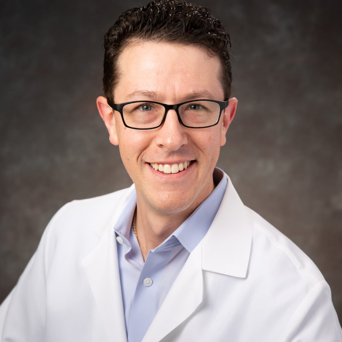 A friendly headshot of Justin Kunes, MD