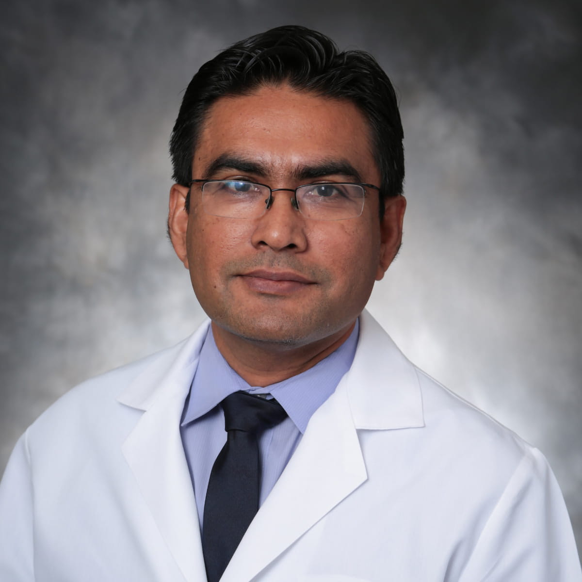 A friendly headshot of Rasik Parmar, MD