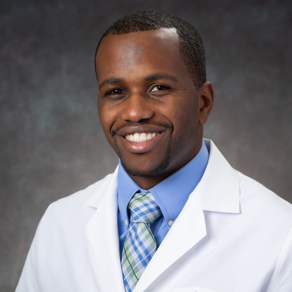 A friendly headshot of Tristan Thomas, MD