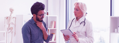 Healthcare provider consults with her patient who is describing his symptoms