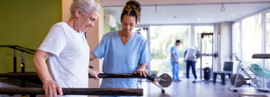 Physical therapist assists a patient on a treadmill
