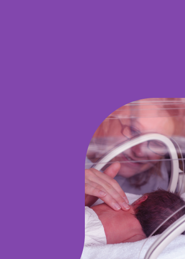 Mother touching baby in isolette