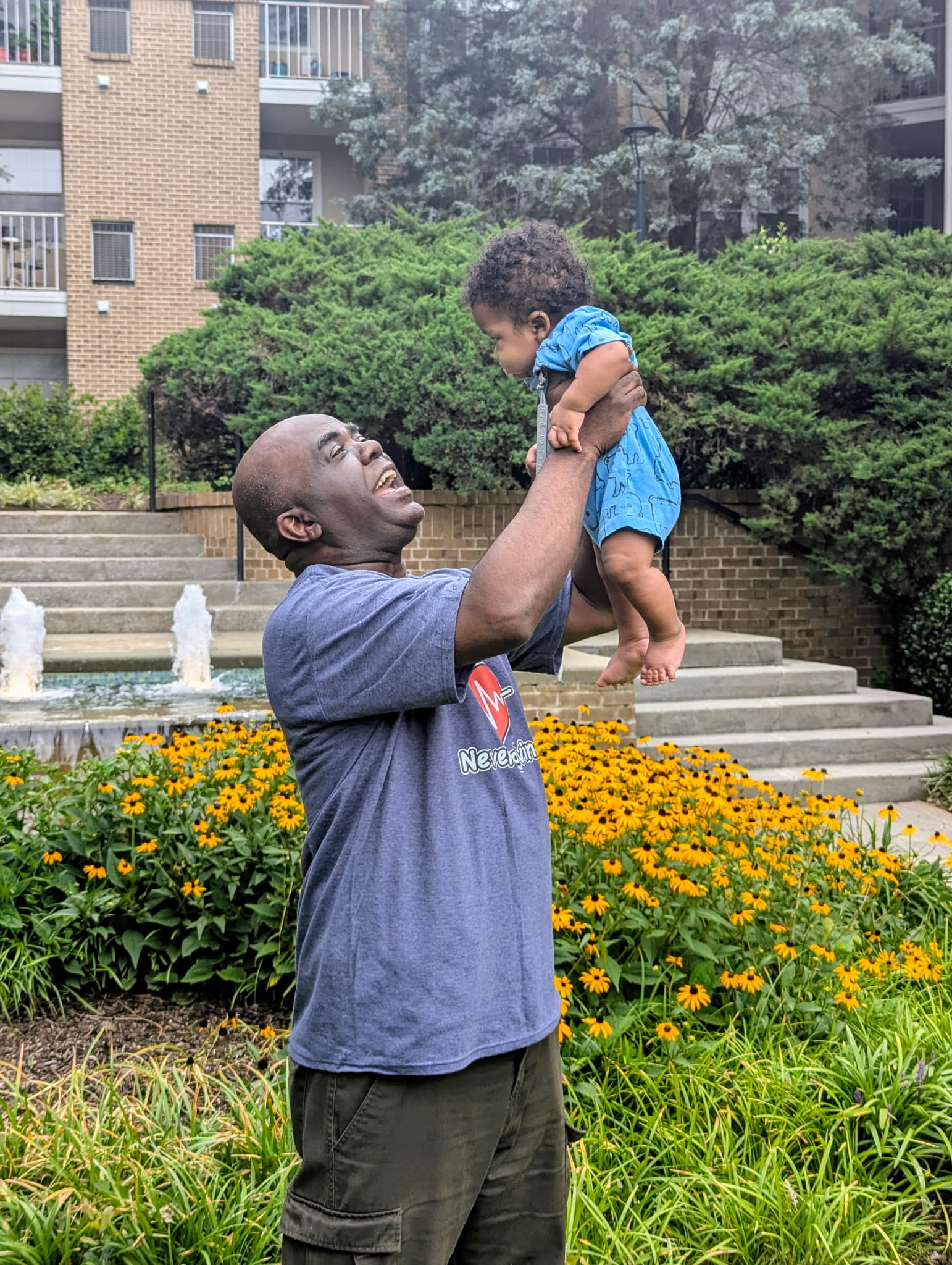 Robert, a new grandfather, holds his infant grandson up in the air as he smiles from ear to ear. With Wellstar helping him manage his HCM, he can keep making memories with his growing family. 